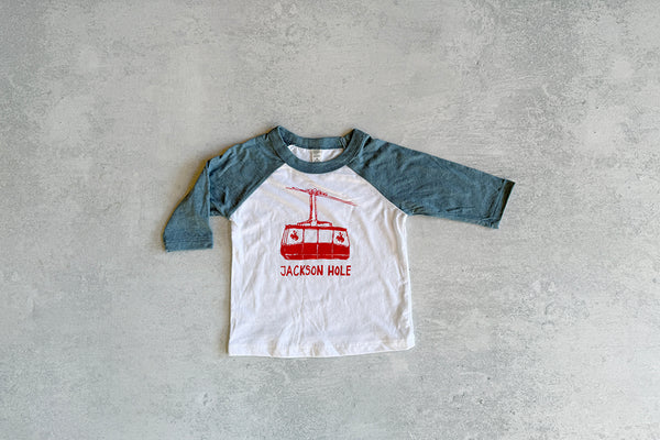 Children's baseball shirt with red graphic and 'Jackson Hole' text on a gray background