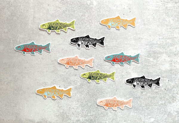 Set of fish-shaped stickers with text on a textured surface