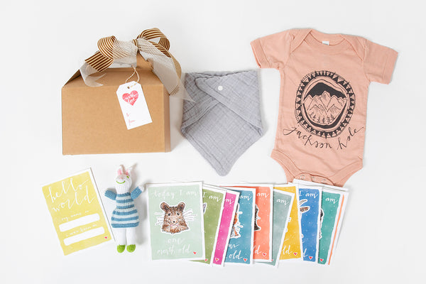 Western newborn baby gift box with onesie and milestone cards